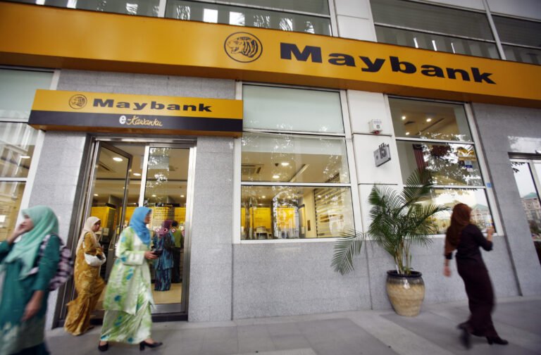 Customers leave a branch of Malaysia's Maybank in Putrajaya